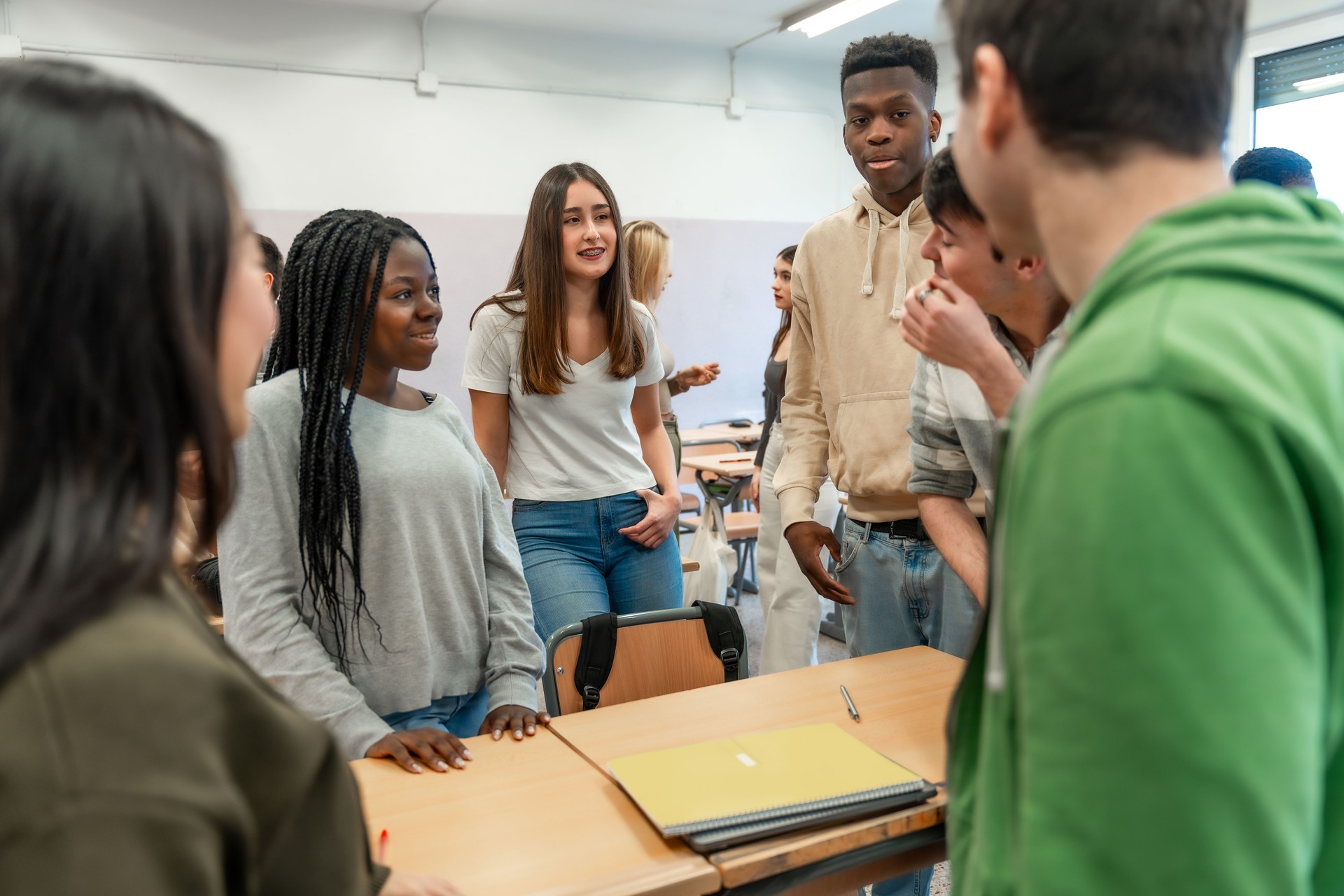 High school students collaborating on a project in classroom